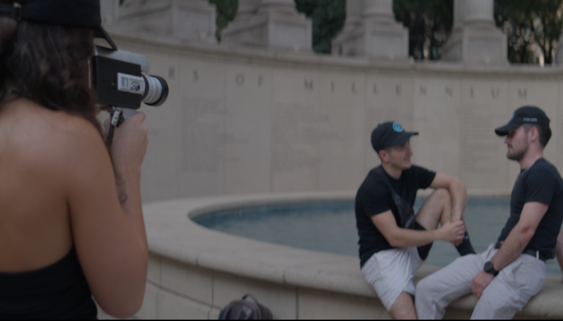 Two Cyan Lens crew members filming by the fountain in Millennium Park