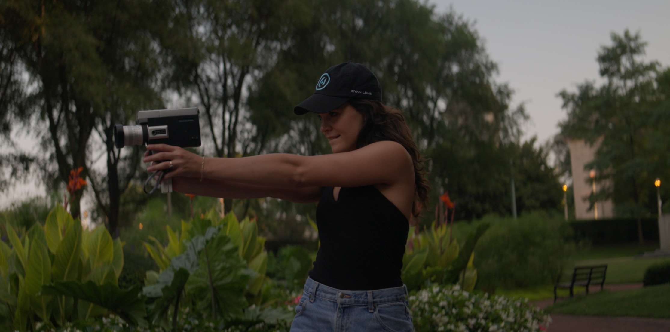 Cyan Lens videographer filming with a handheld camera